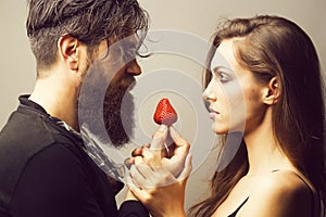 Sexy couple eating red strawberry