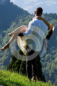 The sexy couple embraced passionately in the nature. A sensual couple in love cuddled tenderly on the summer. The man photo