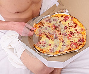 courier delivers gastronomic satisfaction to your bed. Guy naked covered pizza box sit bed bedroom offer you join
