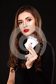 curly hair brunette posing with two aces cards in her hands, poker concept isolation on white background