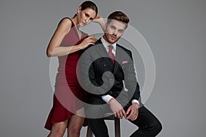 elegant couple posing togther on grey background photo