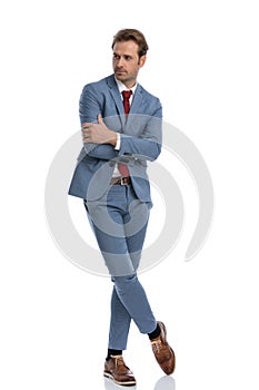 Sexy elegant young man crossing arms and looking to side