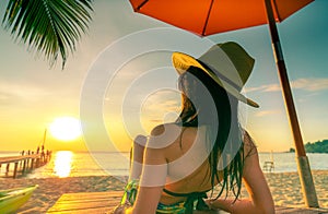 Sexy, enjoy and relax Caucasian woman wear bikini lying and sunbathing on sunbed at sand beach at paradise tropical island under