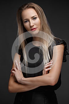 fashion model with long hair, young European attractive, beautiful eyes, perfect skin is posing in studio for