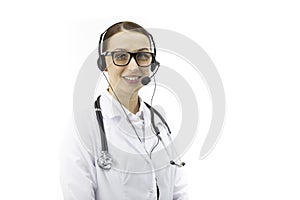 Sexy female doctor in headphones smiles, looks at camera. online patient support