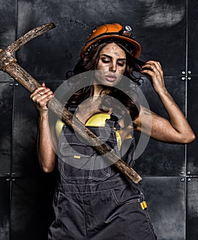female miner worker with pickaxe, in coveralls over his naked body