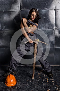 female miner worker with pickaxe, in coveralls over his naked body. erotic industry concept