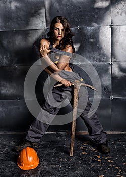 female miner worker with pickaxe, in coveralls over his naked body. erotic industry concept