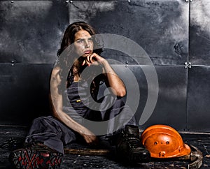 female miner worker with pickaxe, in coveralls over his naked body. erotic industry concept