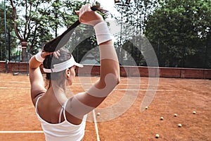 Sexy female tennis player posing on a tennis court