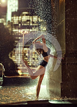 Sexy, fit woman in a fountain