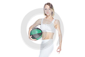 Sexy fitness girl with a soccer ball showing her perfect abdominals on white background