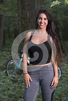 Sexy fmeale mountain biker in shade of forest - summer