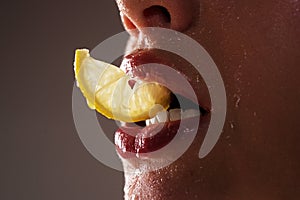 Sexy fruit. Closeup lips with lemons. Vitamin C. Summer refreshment concept. Tea time. Girl with slice of lemon. Macro