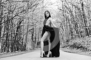 Sexy girl elegant dress high heels at road. Beauty and fashion. Woman in black dress. Elegant lady. Escort concept
