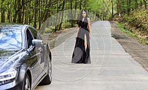 Sexy girl elegant dress at road. Escort concept. Glamorous girl and luxury car. Escort and sexual services. Driver girl