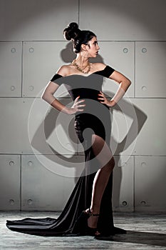 Sexy girl in evening black dress studio