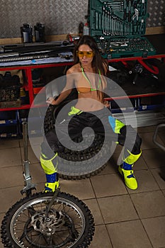 Sexy girl in garage with bike tires