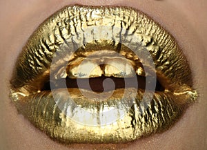 Sexy girl golden lips, gold mouth. Glowing gold skin make-up. Glitter metallic shine golden lipgloss makeup. Golden lip