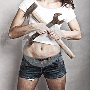 girl holding hammer and wrench spanner