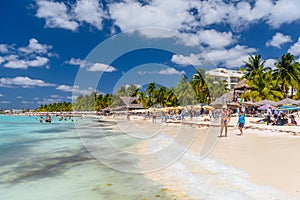 Sexy girl lady standing in blue bikini on a white sand beach, turquoise caribbean sea, Isla Mujeres island, Caribbean Sea, Cancun