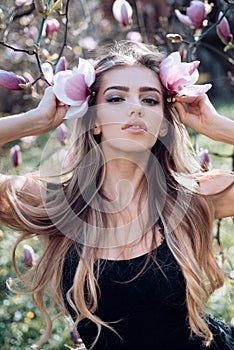 Sexy girl. magnolia blossom. spring. Beauty and fashion. trendy look. Sensual woman. makeup and hair style. long healthy