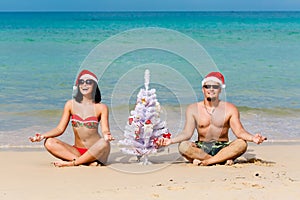 girl man Santa on a beach fir-tree