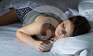 Sexy girl in pygamas sleeping in bed at home