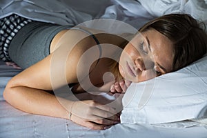 Sexy girl in pygamas sleeping in bed at home