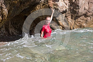 girl in sportswear and tanga string in a sea cave