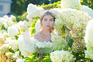 Sexy girl with summer makeup. Spring woman with hydrangea flowers. Summer beauty. Fashion portrait of woman. Healthy