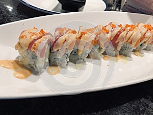 sexy girl sushi roll of tuna and salmon (with fish roe and sauce)