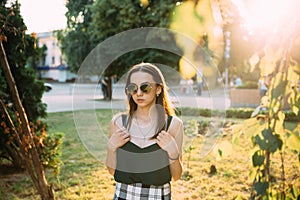 Sexy girl in a T-shirt in an evening park in mini shorts photo