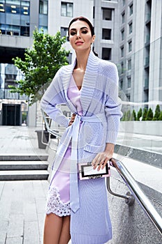 glamour woman in lilac fashion style dress with handbag