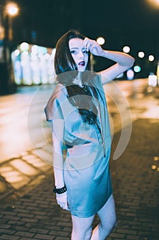 gorgeous brunette girl portrait in night city lights