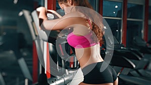 Sexy hot athletic woman runnng in the gym. Sport, fitness, lifestyle, beauty concept. Filmed on cinemacamera.