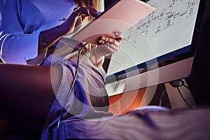 Sexy lady is sitting on the table while working