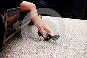 legs alighting from car