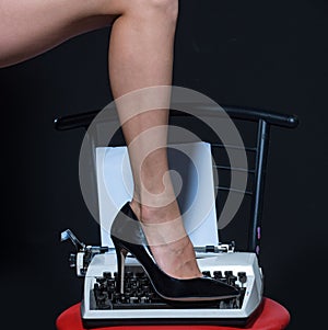 legs. retro typewriter. modern fashion. fetish wear shoes on leg of woman. seducing you. love education. epilation photo
