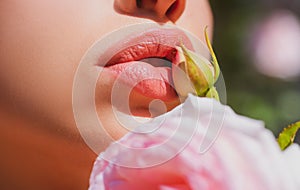 Sexy Lips. Beauty Red Lips Makeup Detail. Lips with spring flowers closeup. Beautiful woman lips with rose.