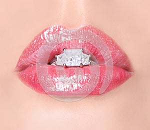 Lips with Diamond Ring. Beauty Pink Lip Gloss. Mouth