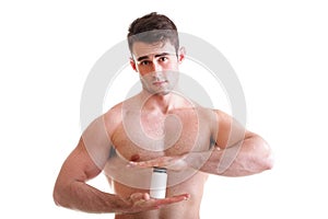 male body builder holding a boxes with supplements on his b