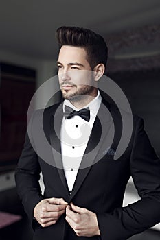 man celebrity in tuxedo indoor photo