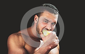 Sexy man eat apple. Close up guy face.