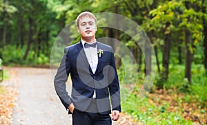 man in tuxedo and bow tie posing