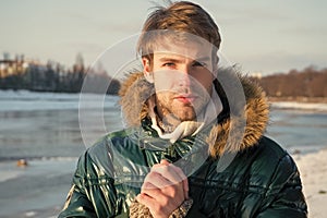 Sexy man in warm clothes. Warm clothes for cold season. Man traveling in winter, nature. Winter fashion. Green warm coat