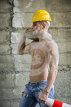 Sexy, muscular handsome construction worker shirtless, outdoor shot