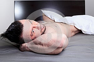 A naked man lay in the bed