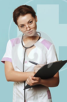 Sexy nurse on blue background with stethoscope