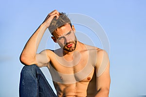 Sexy pensive man relaxing outdoors. Male beauty. Fashion guy. Attractive and mysterious. Athletic handsome macho